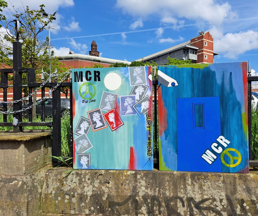 &lsquo;MCR One Love&rsquo; postage-stamp painting beside a blue abstract canvas with a door outline and peace sign