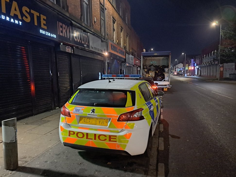 A police car parked outside shuttered shops on the Road during Operation Vulcan, the raid on the counterfeit goods trade