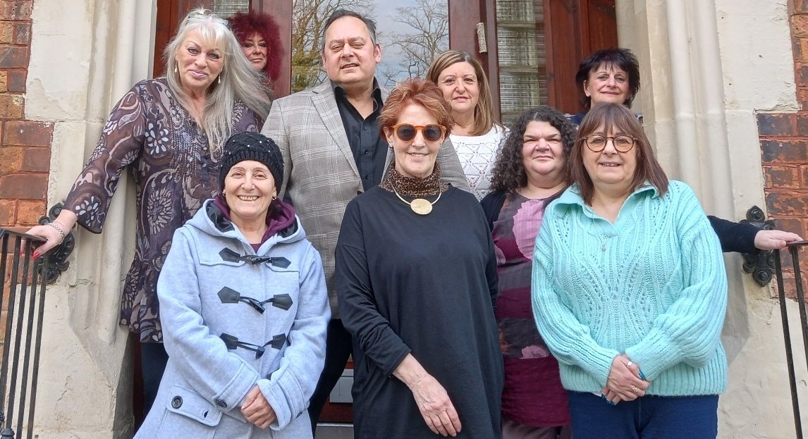 A group of workshop participants gathered on the steps of a building in Bury New Road
