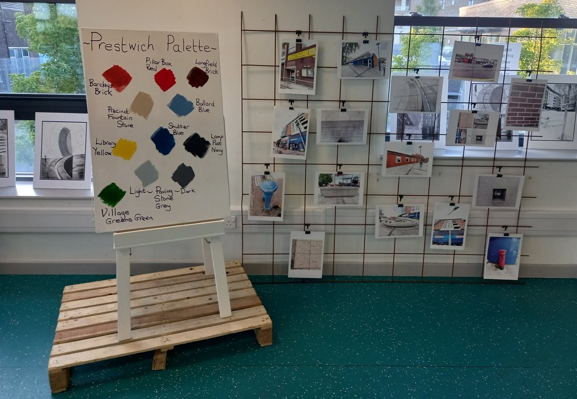 A &lsquo;Prestwich Palette&rsquo; colour-swatch board on an easel beside a grid of local landmark photographs from a workshop