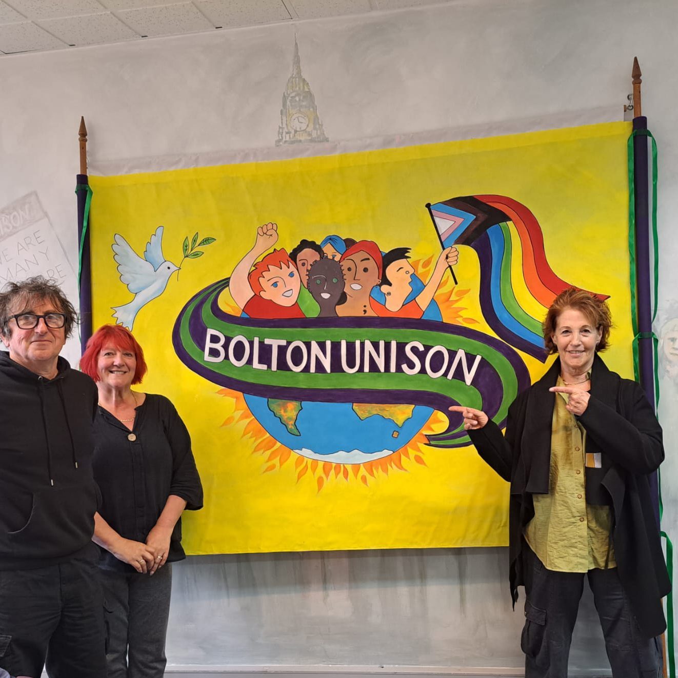 Hand-painted Bolton Unison banner featuring a dove, a diverse group of figures and a Pride flag