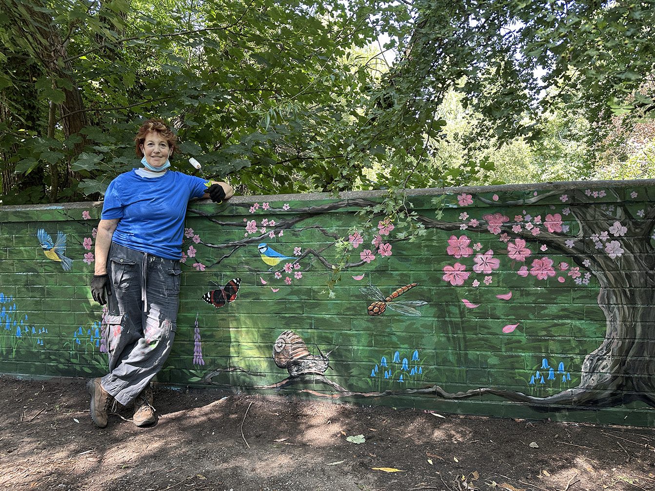 Louise Garman beside the completed wildlife mural in Trittiford Park