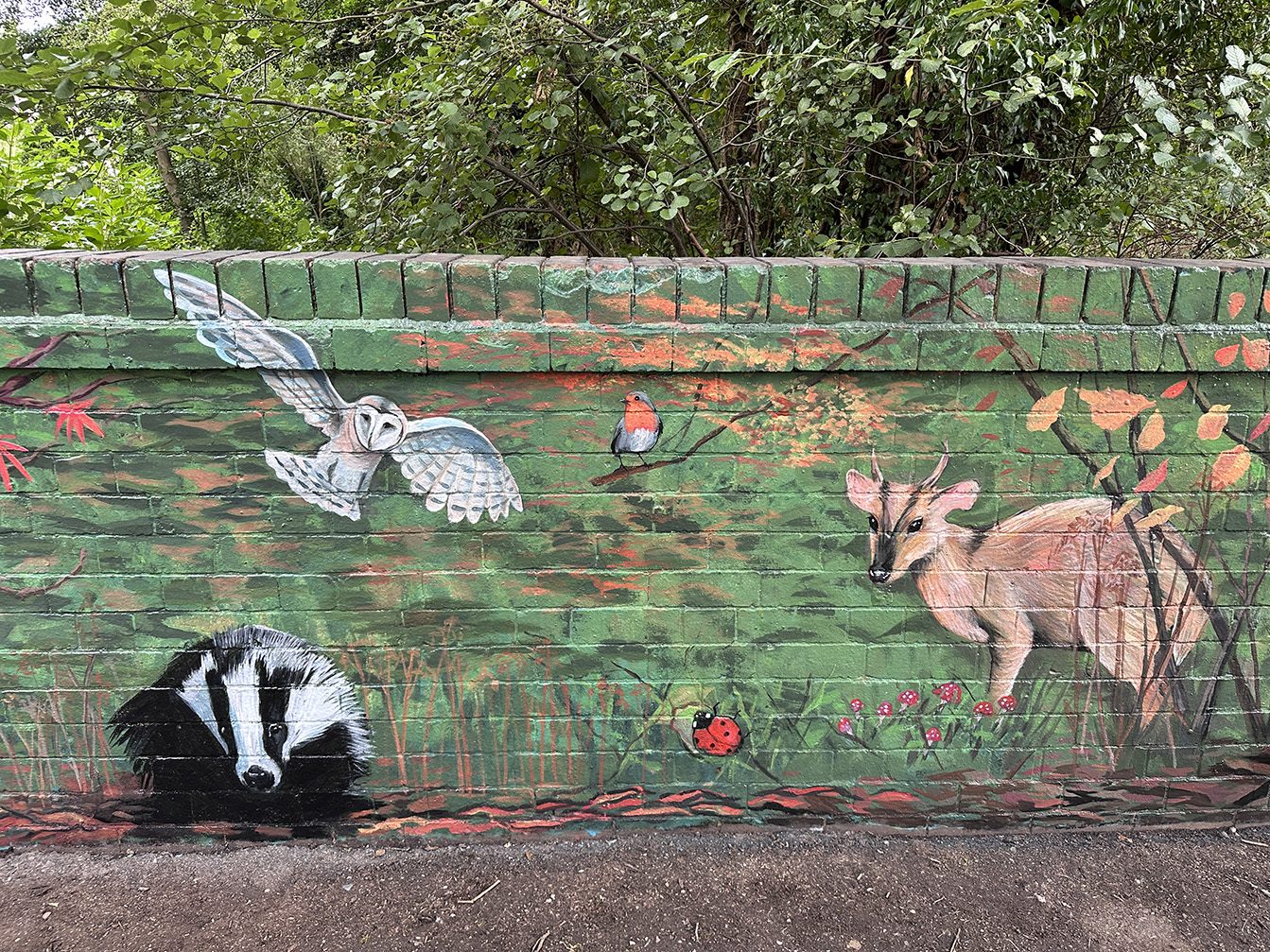 Autumn scene from the mural with a barn owl, robin, badger and deer
