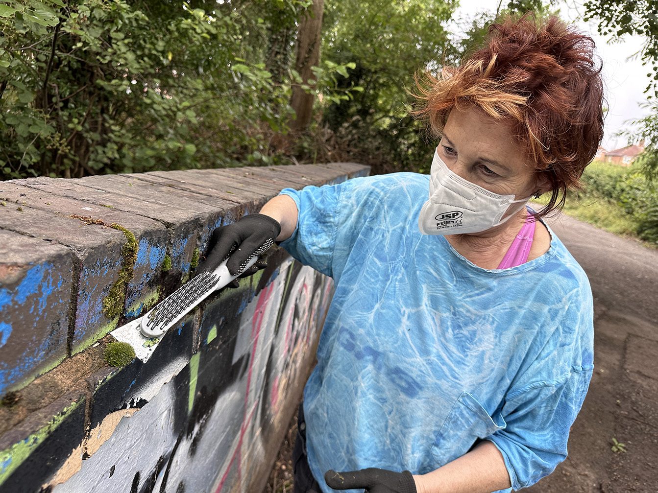 Louise Garman preparing the wall before painting