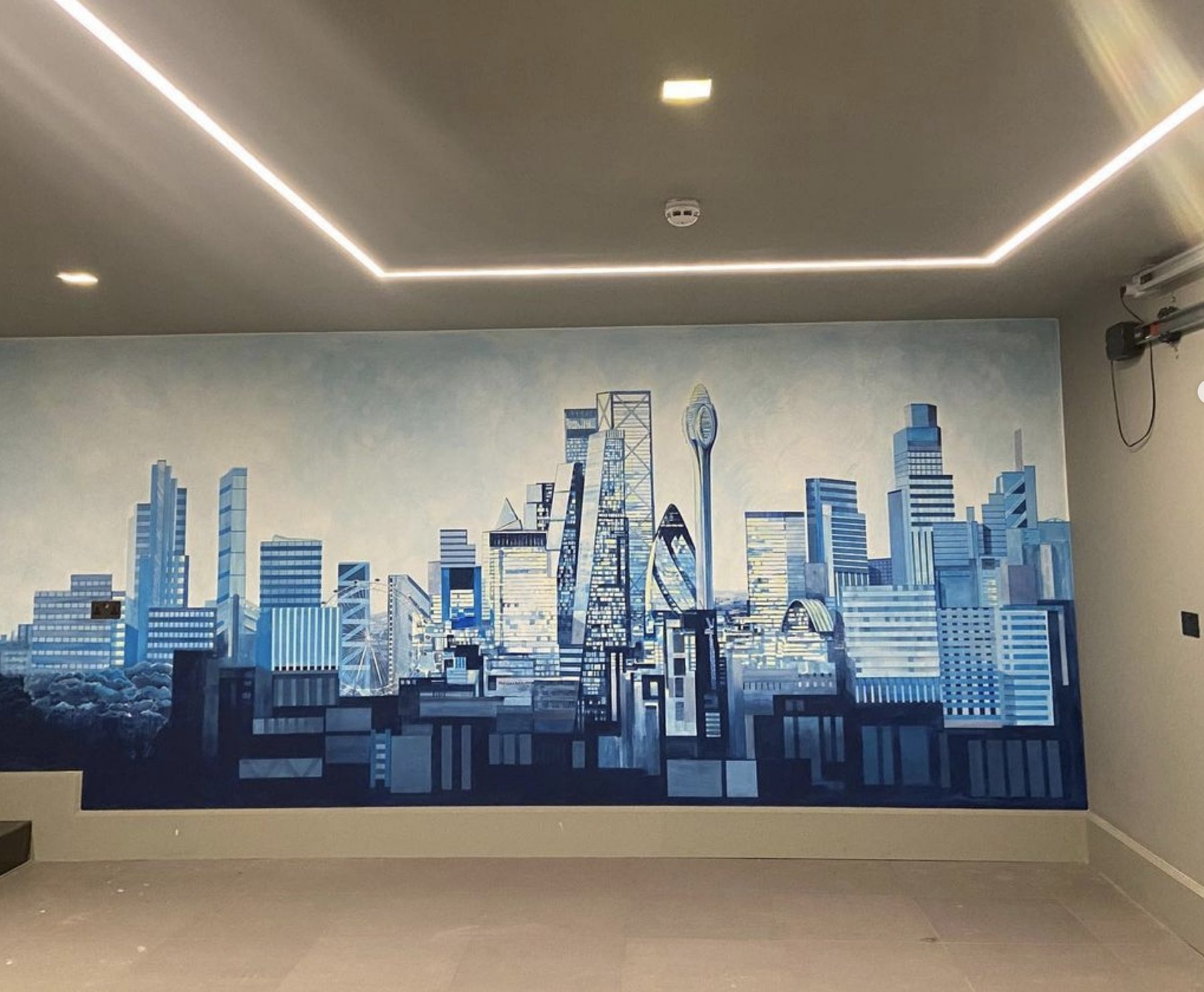 Hand-painted London skyline mural spanning a full wall, featuring the Gherkin, the Shard and the BT Tower