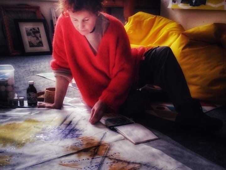 Louise Garman working on a large canvas piece in her studio