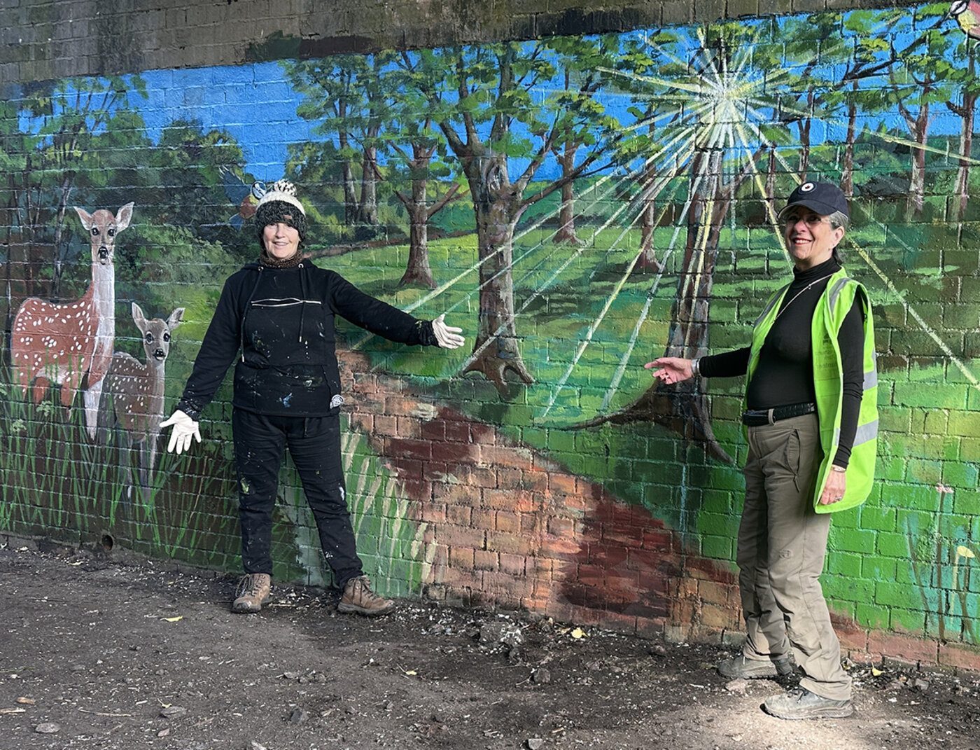 Louise Garman and a colleague at the mural