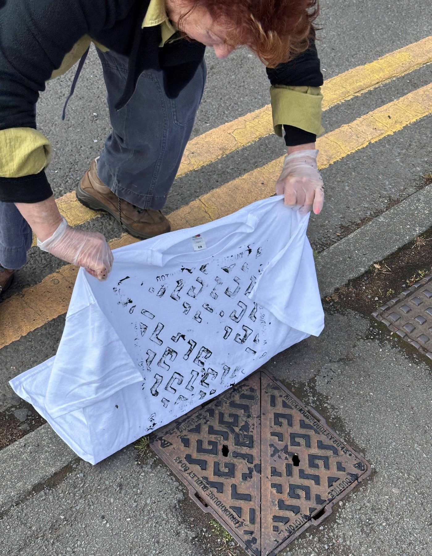 Four participants holding their grid prints and a printed t-shirt