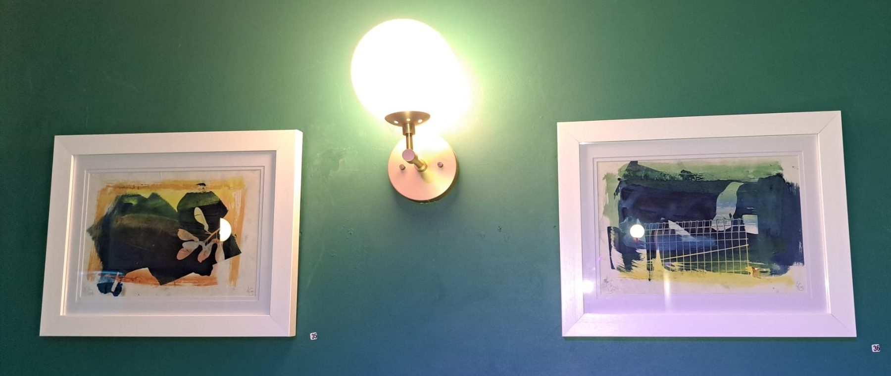 Two more of Louise Garman's framed prints hanging at The Crooked Man