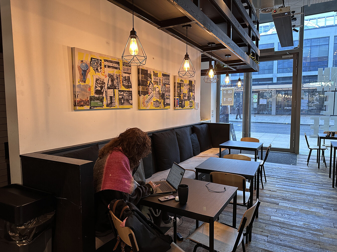 Three framed Bury New Road collages by Louise Garman on display at 92 Degrees Coffee, Quay Street