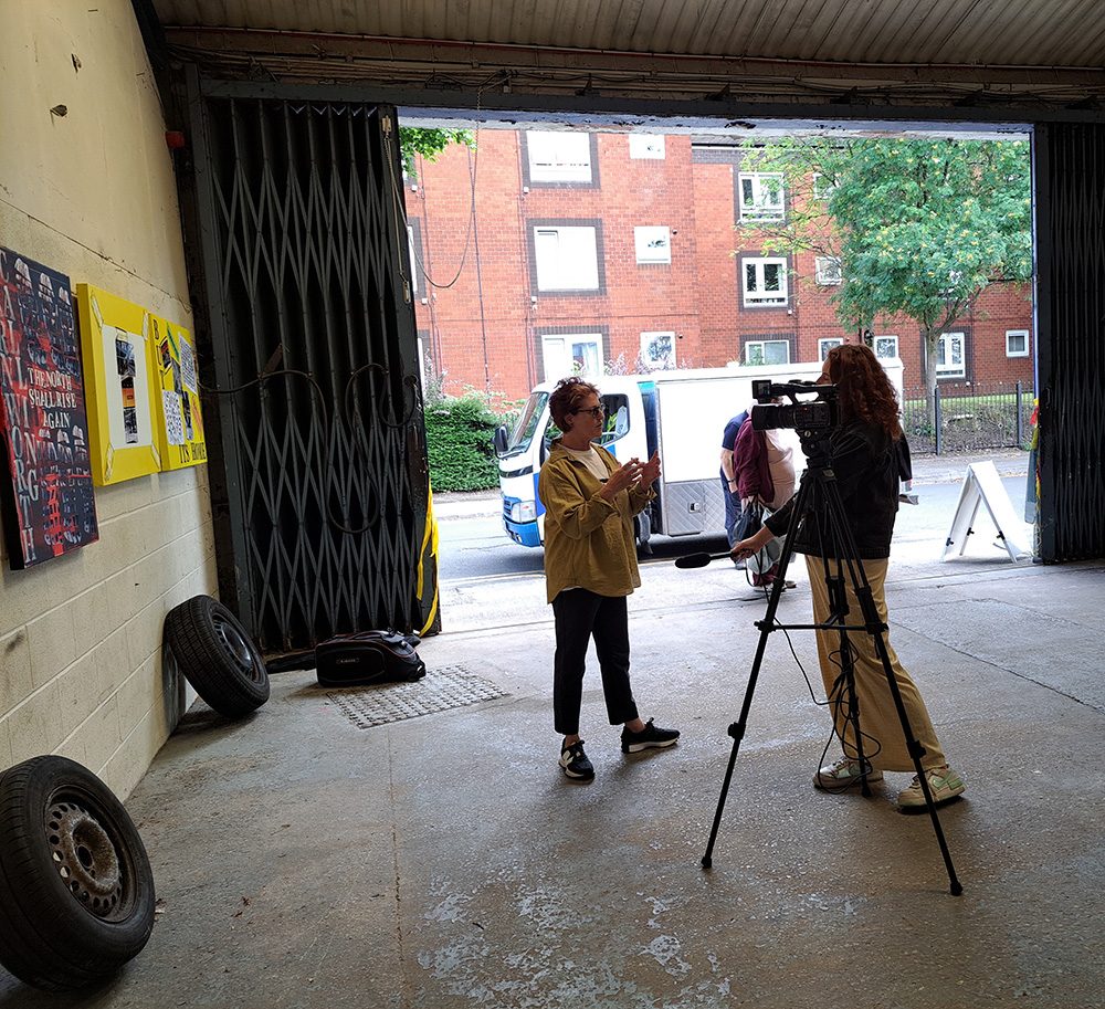Louise Garman being interviewed by a TV camera crew