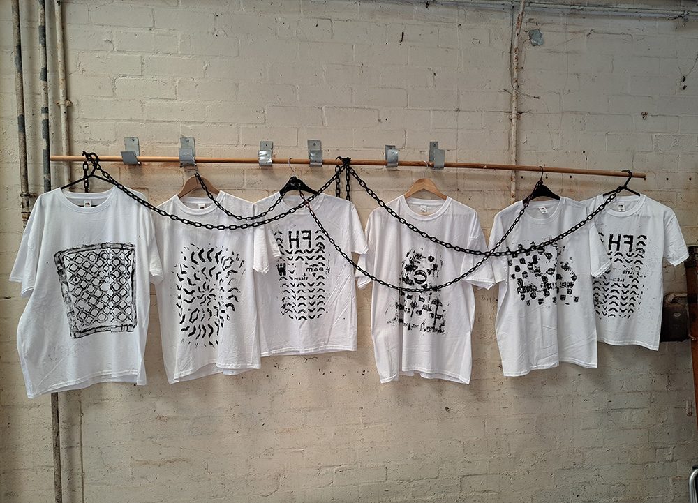 A row of grid-print t-shirts created during the project