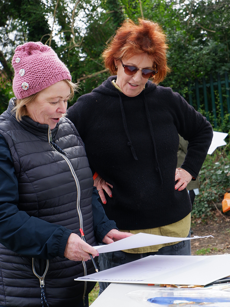 Louise Garman looking over a participant's sketch