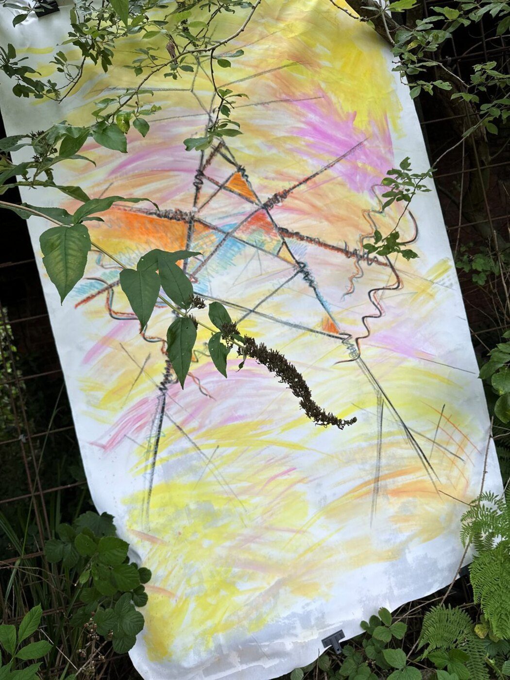 Louise Garman with a hand-painted fabric hanging at Philips Park