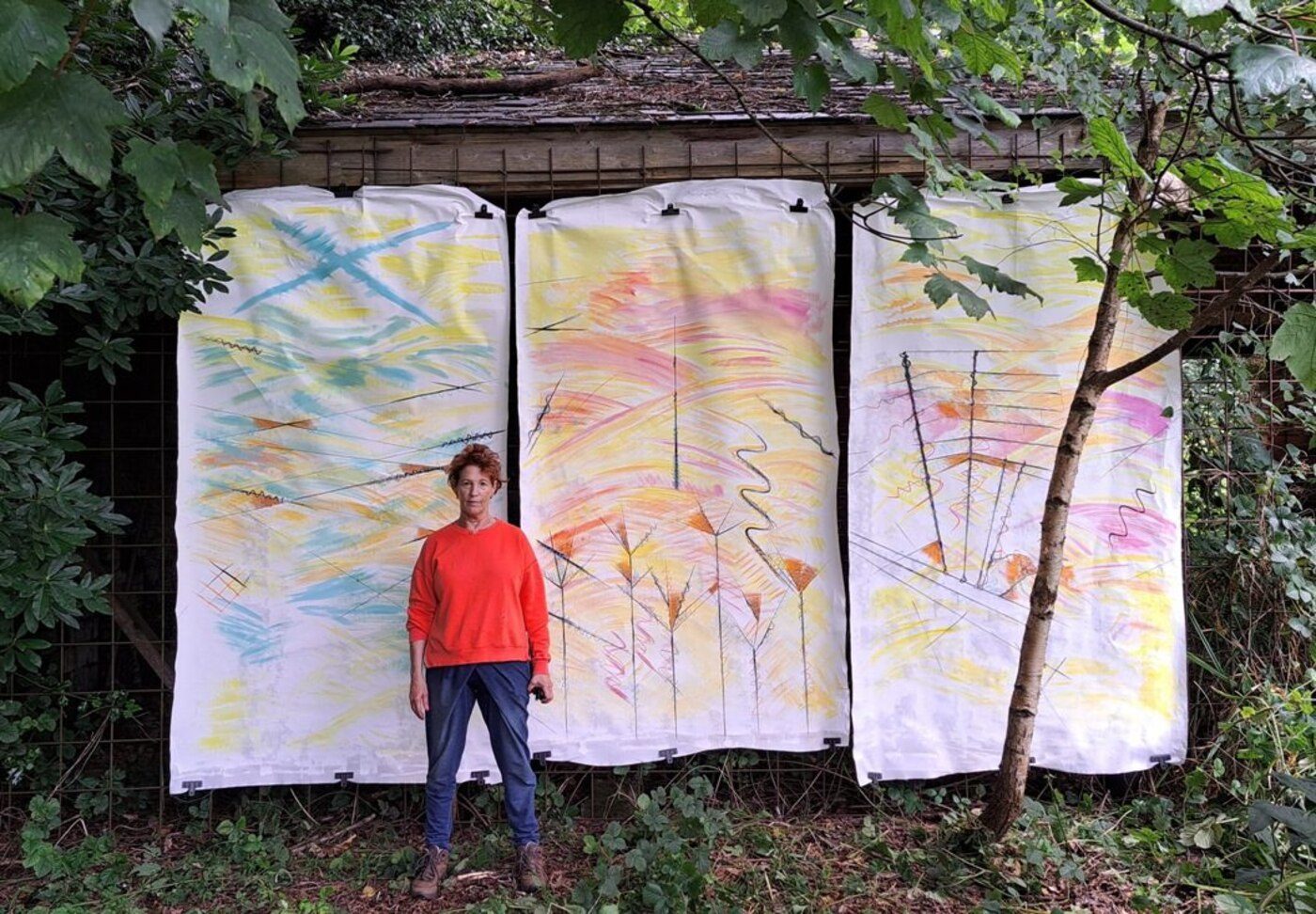 Three hand-painted fabric panels hung outdoors at Philips Park